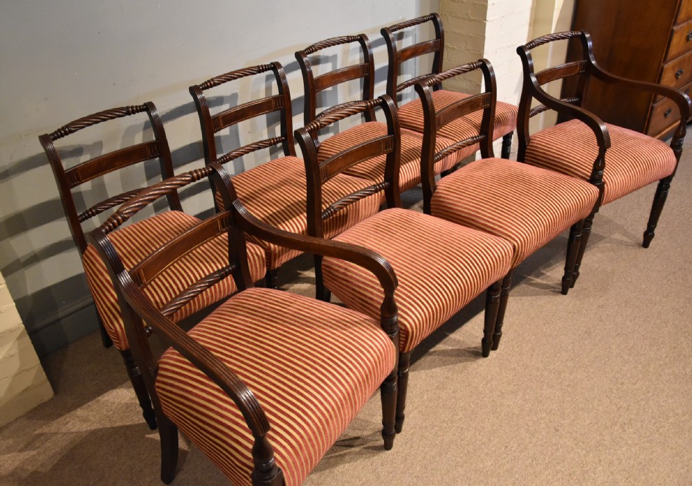 A set of eight Regency mahogany dining chairs featuring carved rope-twist top rails and striped upholstered seats. View III
