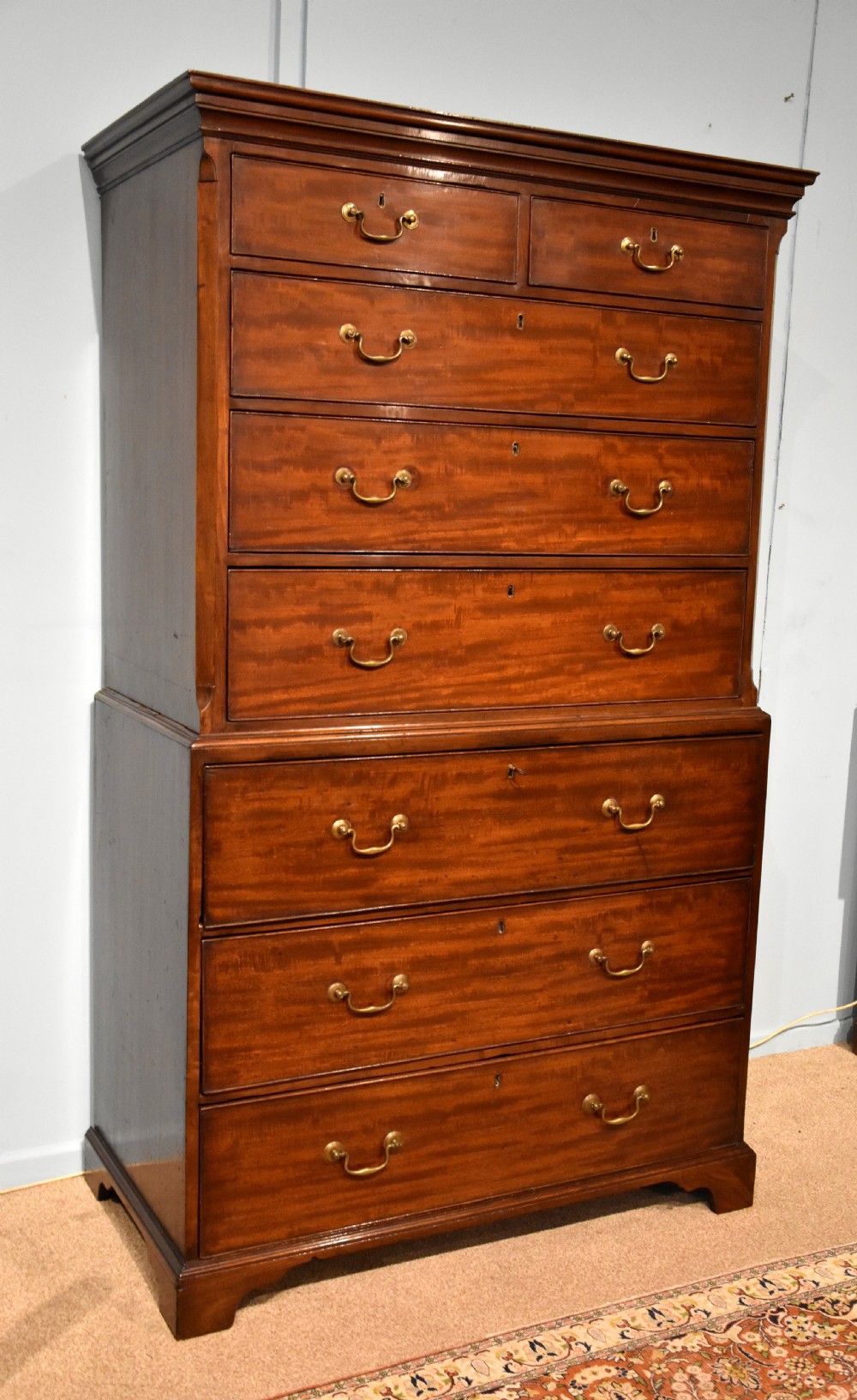 An eighteenth-century mahogany chest on chest featuring two short over six long graduated drawers with brass swan-neck handles and bracket feet. View III