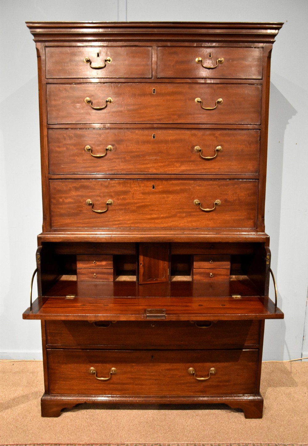 An eighteenth-century mahogany chest on chest featuring two short over six long graduated drawers with brass swan-neck handles and bracket feet. View IV