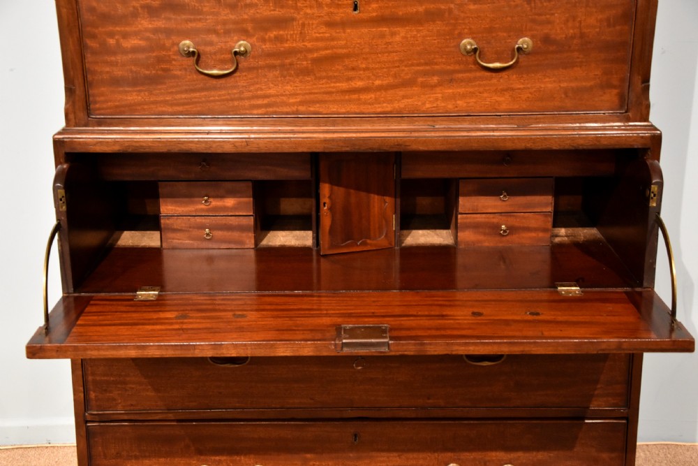 An eighteenth-century mahogany chest on chest featuring two short over six long graduated drawers with brass swan-neck handles and bracket feet. View V
