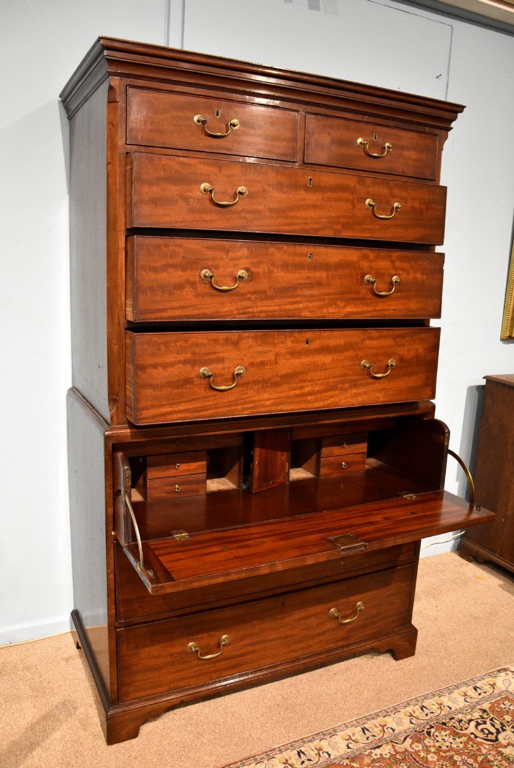 An eighteenth-century mahogany chest on chest featuring two short over six long graduated drawers with brass swan-neck handles and bracket feet. View VI