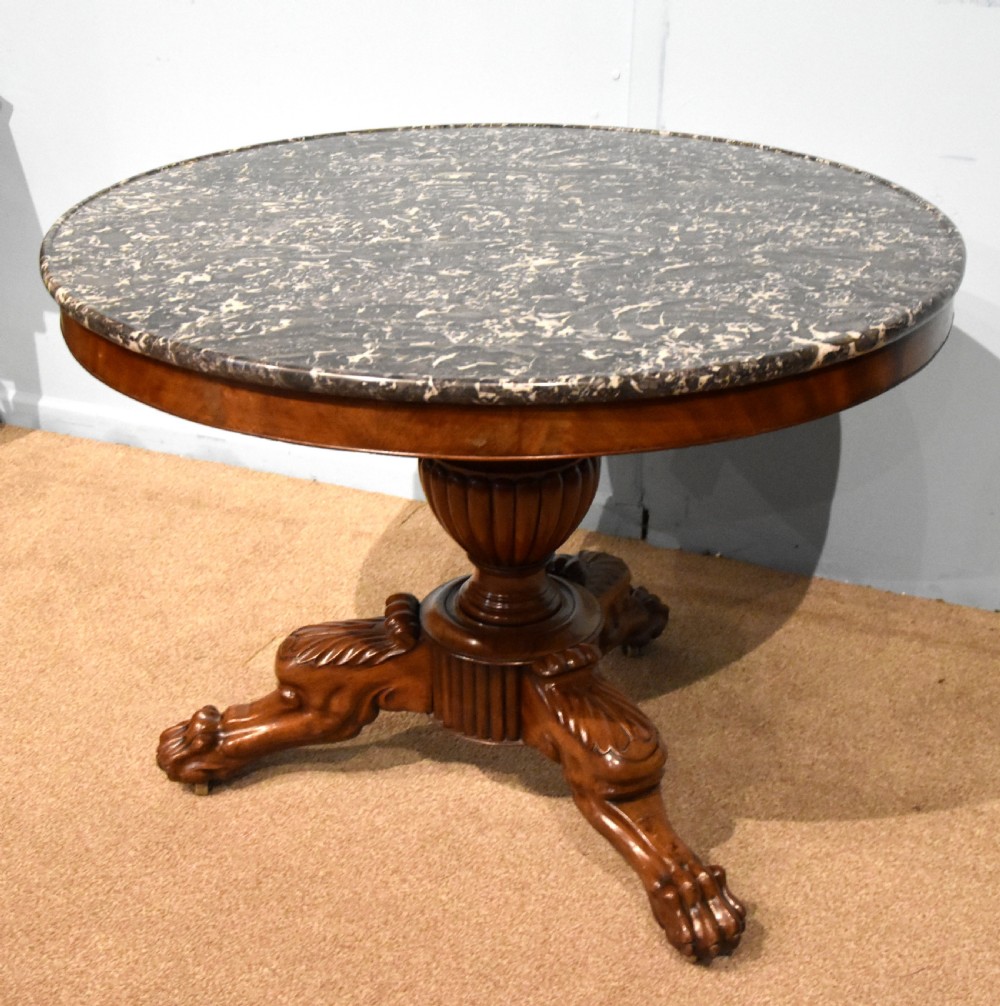 A 19th-century French mahogany gueridon table featuring a circular dark marble top supported by a reeded pedestal stem and carved triform base with paw feet. View II