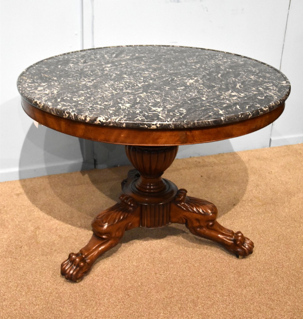 A 19th-century French mahogany gueridon table featuring a circular dark marble top supported by a reeded pedestal stem and carved triform base with paw feet. View III