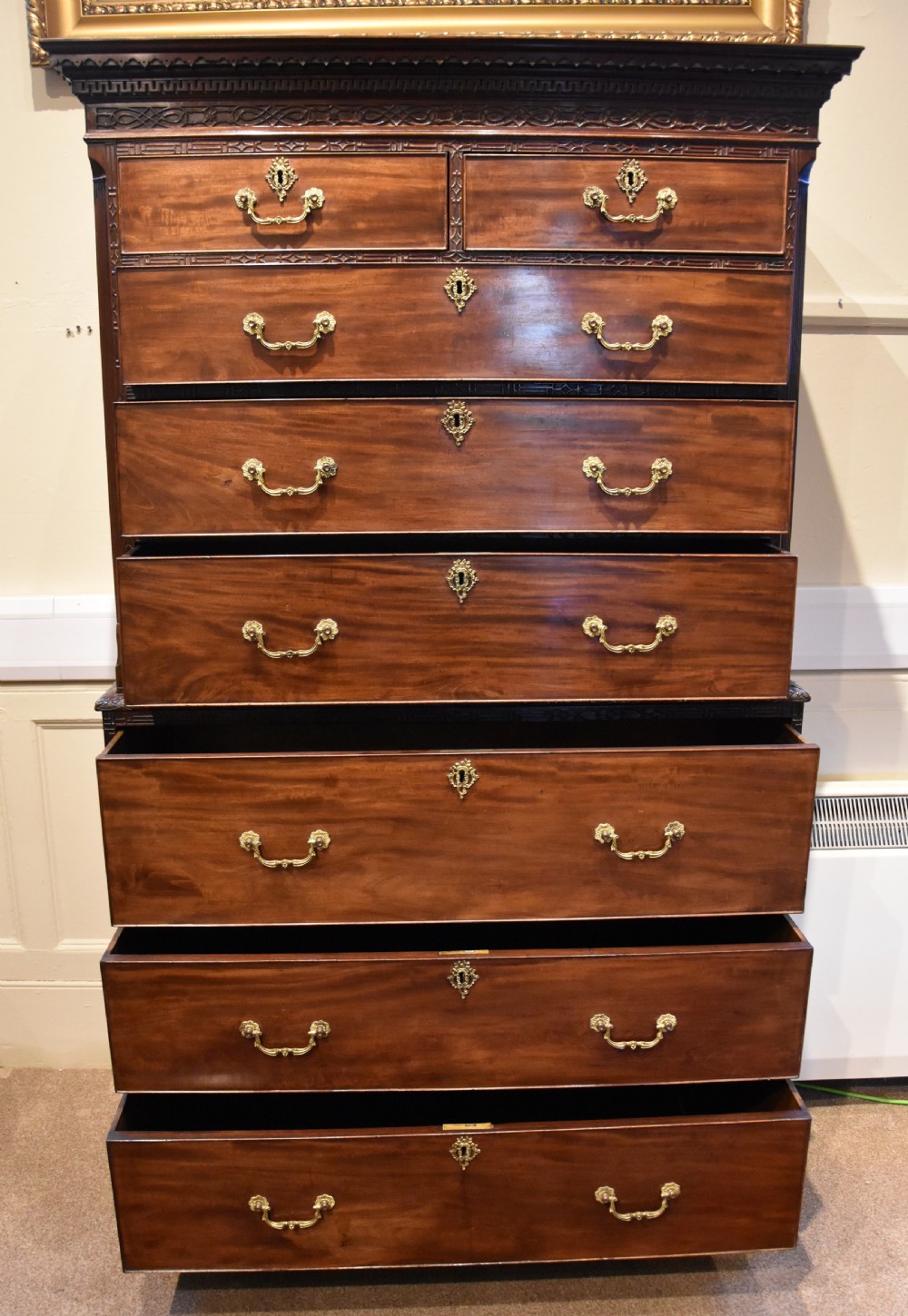 An eighteenth-century carved mahogany chest on chest featuring geometric fretwork mouldings, brass swan-neck handles, and carved bracket feet. View III