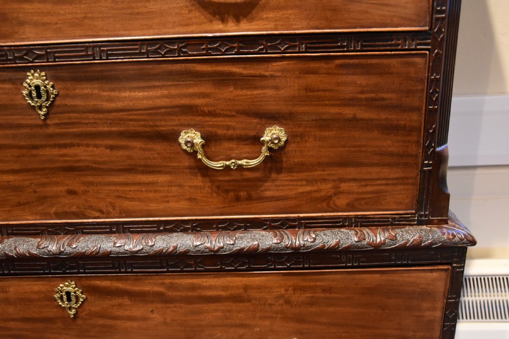 An eighteenth-century carved mahogany chest on chest featuring geometric fretwork mouldings, brass swan-neck handles, and carved bracket feet. View IV
