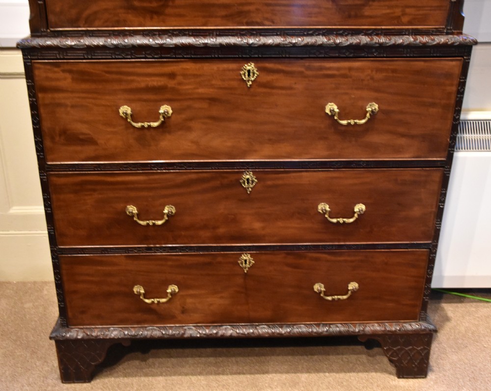 An eighteenth-century carved mahogany chest on chest featuring geometric fretwork mouldings, brass swan-neck handles, and carved bracket feet. View VIII