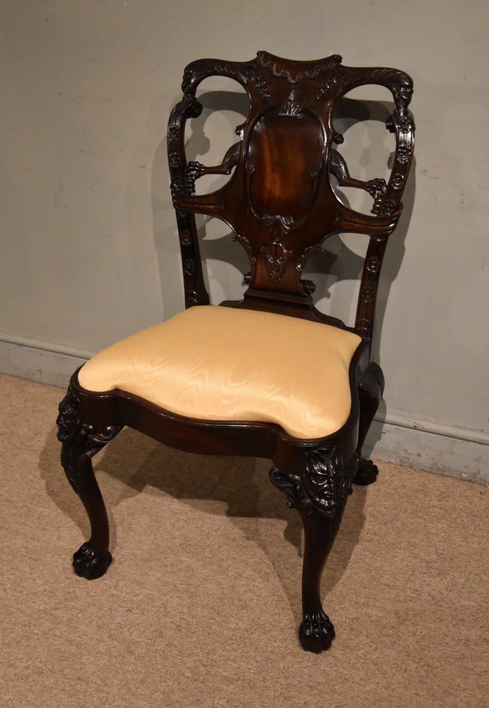 A 19th-century Cuban mahogany side chair featuring an openwork carved back, gold fabric seat, and cabriole legs with claw and ball feet. View II