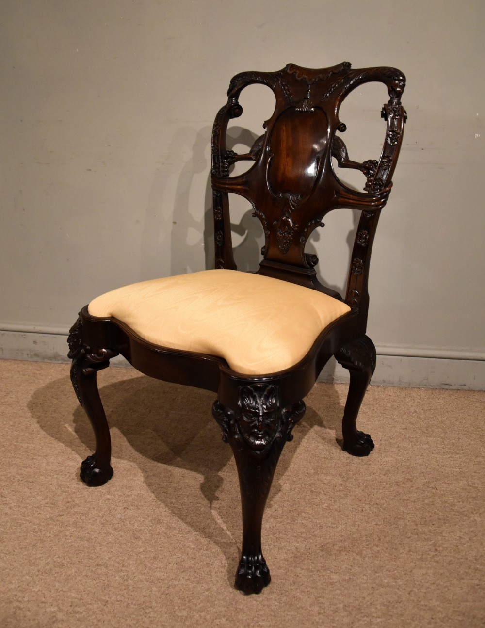 A 19th-century Cuban mahogany side chair featuring an openwork carved back, gold fabric seat, and cabriole legs with claw and ball feet. View VI