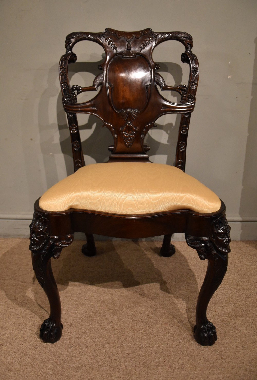 A 19th-century Cuban mahogany side chair featuring an openwork carved back, gold fabric seat, and cabriole legs with claw and ball feet. View VII