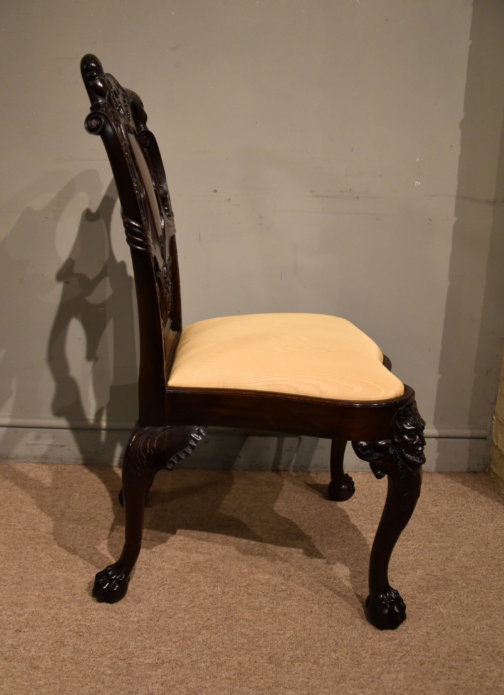 A 19th-century Cuban mahogany side chair featuring an openwork carved back, gold fabric seat, and cabriole legs with claw and ball feet. View VIII