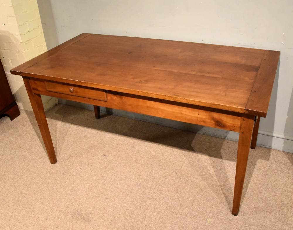 A mid 19th-century French farmhouse table in warm brown fruitwood featuring a single frieze drawer and tapered square legs. View II