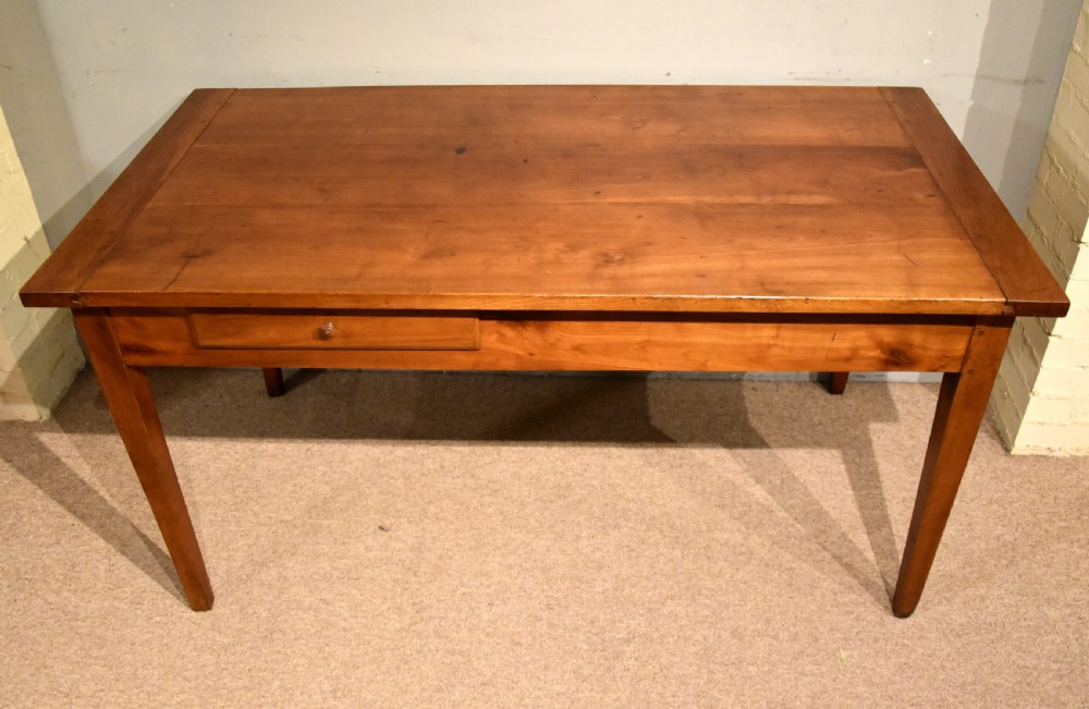 A mid 19th-century French farmhouse table in warm brown fruitwood featuring a single frieze drawer and tapered square legs. View III