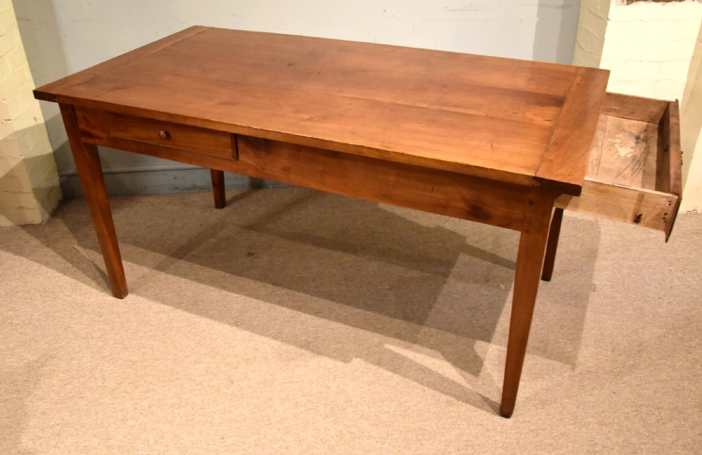 A mid 19th-century French farmhouse table in warm brown fruitwood featuring a single frieze drawer and tapered square legs. View VI
