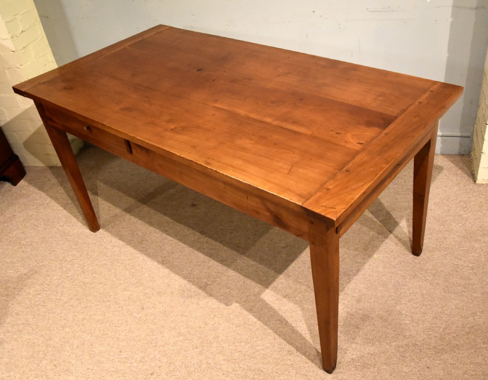 A mid 19th-century French farmhouse table in warm brown fruitwood featuring a single frieze drawer and tapered square legs. View VII