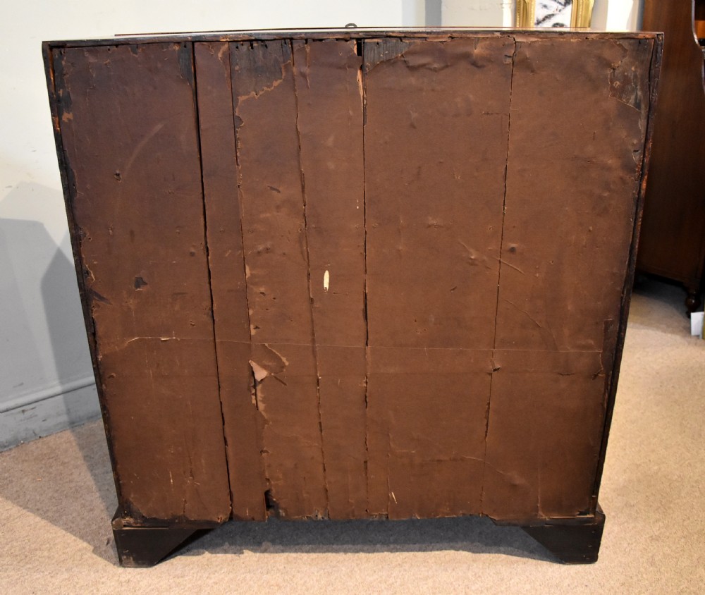 A George II walnut veneered bureau featuring a slant-front writing lid above four drawers with decorative brass handles and bracket feet. View XIII
