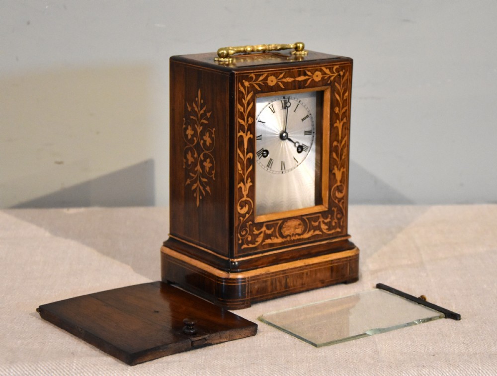 An antique French rectangular rosewood mantel clock featuring foliate marquetry inlay, a silvered engine-turned dial with Roman numerals, and a gilt brass handle. View III