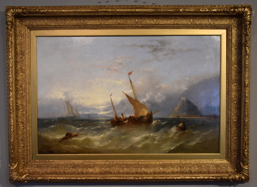 A Victorian oil painting depicting fishing boats on turbulent waters off St Michaels Mount set within an ornate gold gilt frame.