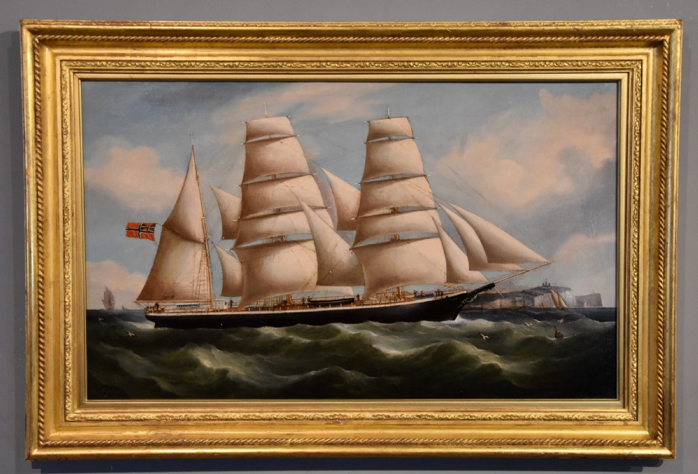 An antique oil painting depicting a three-masted Norwegian barque sailing on green seas within a moulded gold leaf frame.