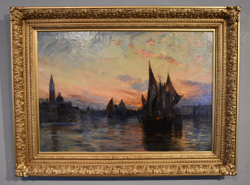 An antique oil painting depicting Venetian sailing boats at sunset framed within an elaborate carved gilt frame.