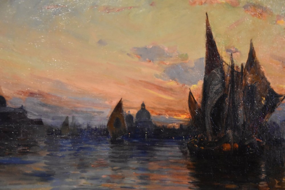An antique oil painting depicting Venetian sailing boats at sunset framed within an elaborate carved gilt frame. View III