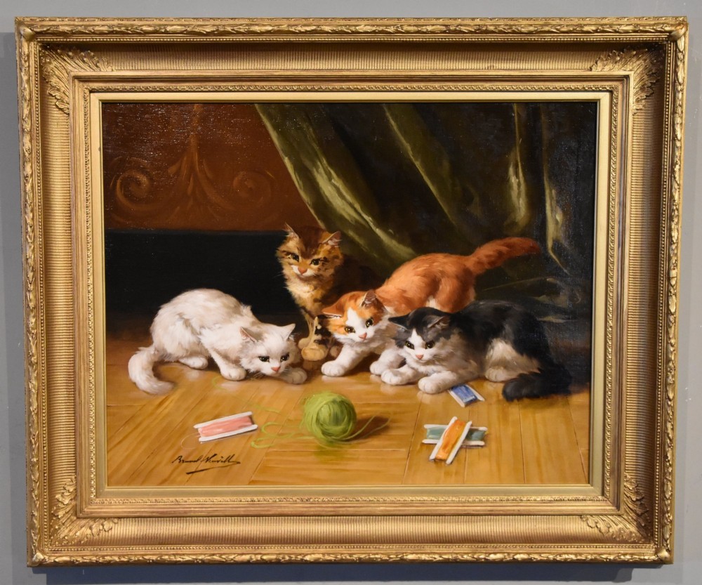 An antique oil painting depicting four kittens playing with yarn on a wooden floor, enclosed in a gilded frame.