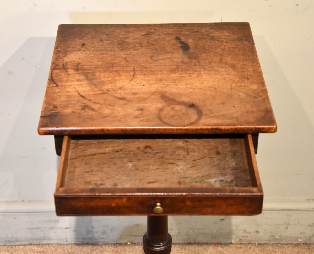 Mid-18th-century mahogany wine table featuring a rectangular top with a small drawer, supported by a turned central stem and three cabriole legs. View IV