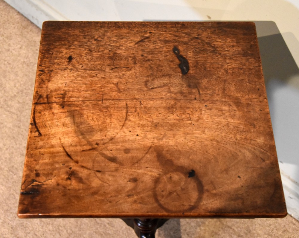 Mid-18th-century mahogany wine table featuring a rectangular top with a small drawer, supported by a turned central stem and three cabriole legs. View VII