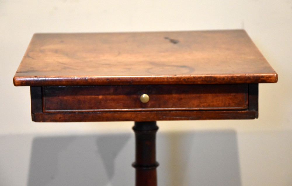 Mid-18th-century mahogany wine table featuring a rectangular top with a small drawer, supported by a turned central stem and three cabriole legs. View VIII