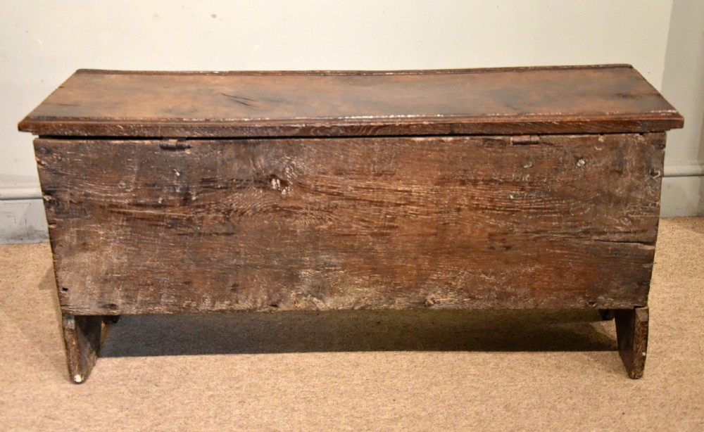 A sixteenth-century dark oak coffer featuring vertical fluted carvings across the front panel and a metal keyhole escutcheon. View VIII