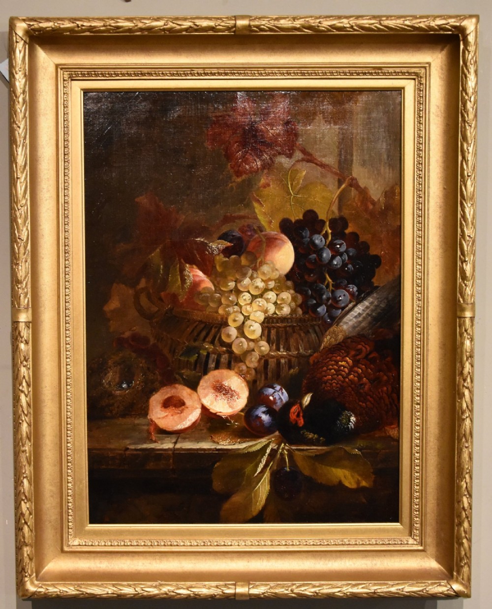A 19th-century Victorian still life oil painting depicting grapes, peaches, plums, and game birds set within a gilded frame.