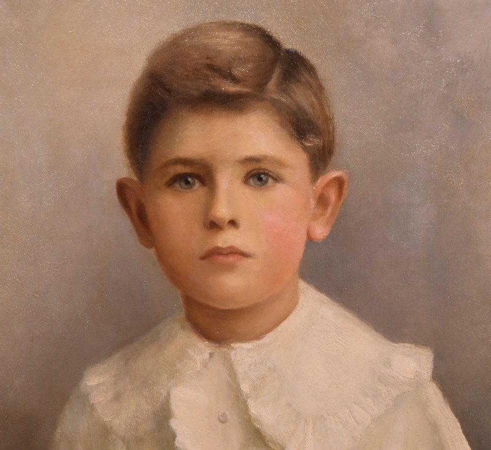 An antique framed oil painting on canvas depicting a young boy wearing a white ruffled collar. View II