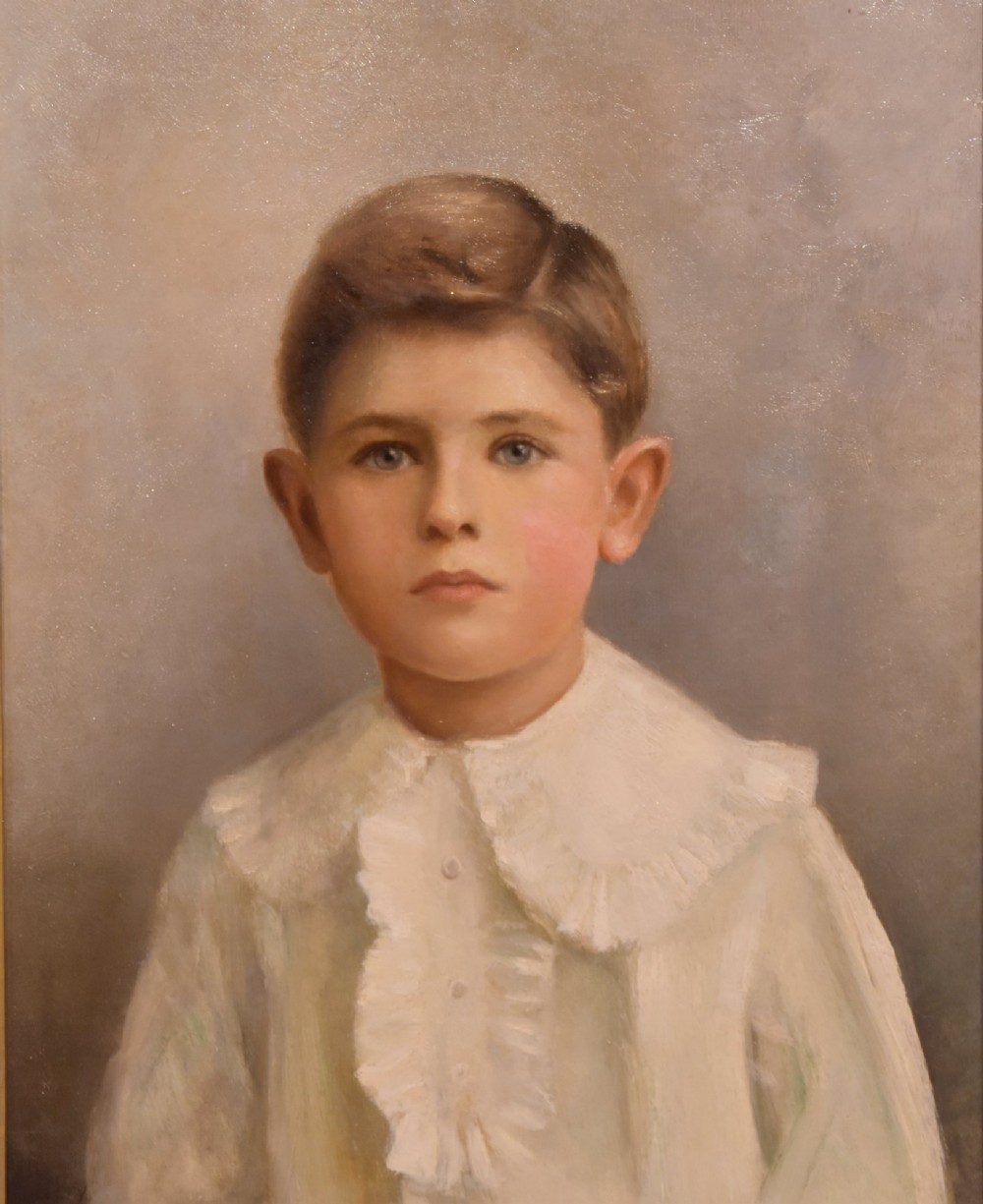 An antique framed oil painting on canvas depicting a young boy wearing a white ruffled collar. View IV