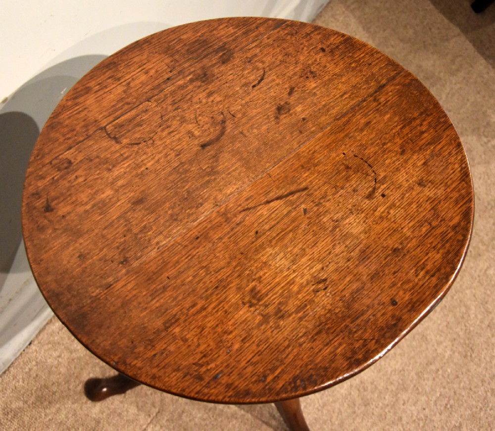 A small Georgian mahogany tripod wine table featuring a circular top, turned central baluster pedestal, and three cabriole legs with pad feet. View II