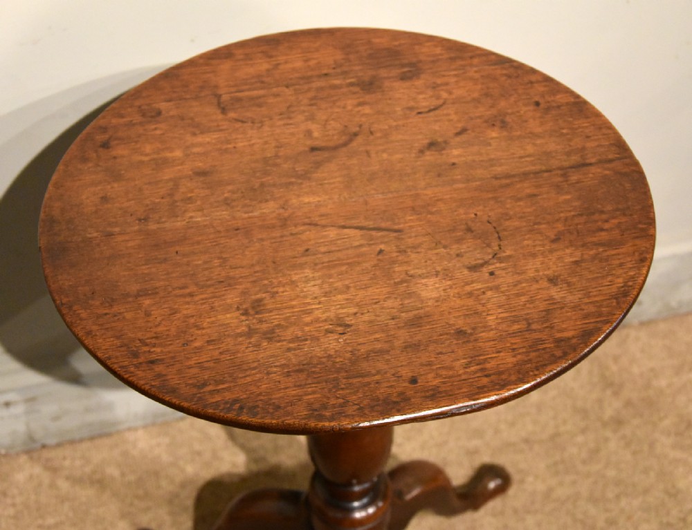 A small Georgian mahogany tripod wine table featuring a circular top, turned central baluster pedestal, and three cabriole legs with pad feet. View III