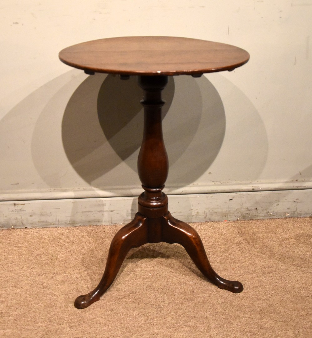 A small Georgian mahogany tripod wine table featuring a circular top, turned central baluster pedestal, and three cabriole legs with pad feet. View V