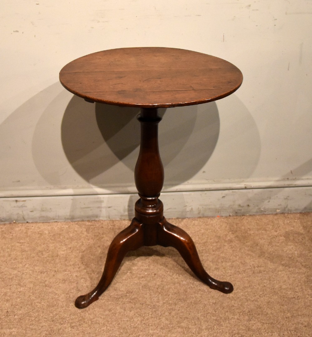 A small Georgian mahogany tripod wine table featuring a circular top, turned central baluster pedestal, and three cabriole legs with pad feet. View VI