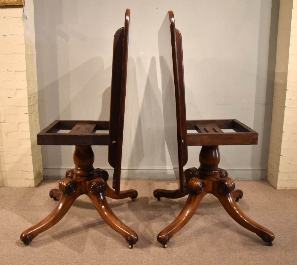A Regency period mahogany extending dining table supported by two turned pedestal bases with reeded splayed legs and brass castors. View VIII