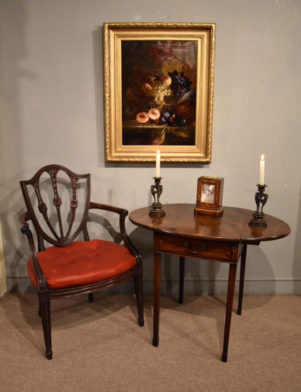 An 18th-century Georgian mahogany Pembroke table featuring an oval drop-leaf top, a frieze drawer with a brass handle, and four square tapered legs. View II