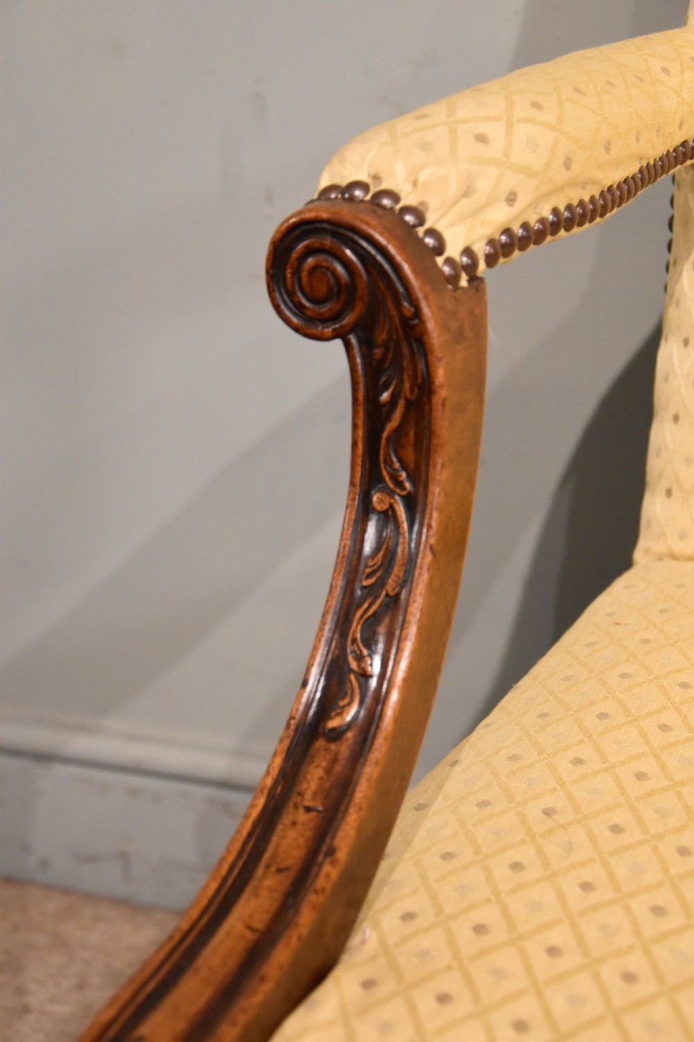 A George III mahogany Gainsborough library armchair upholstered in yellow patterned fabric with scroll arms and brass stud trim. View VI