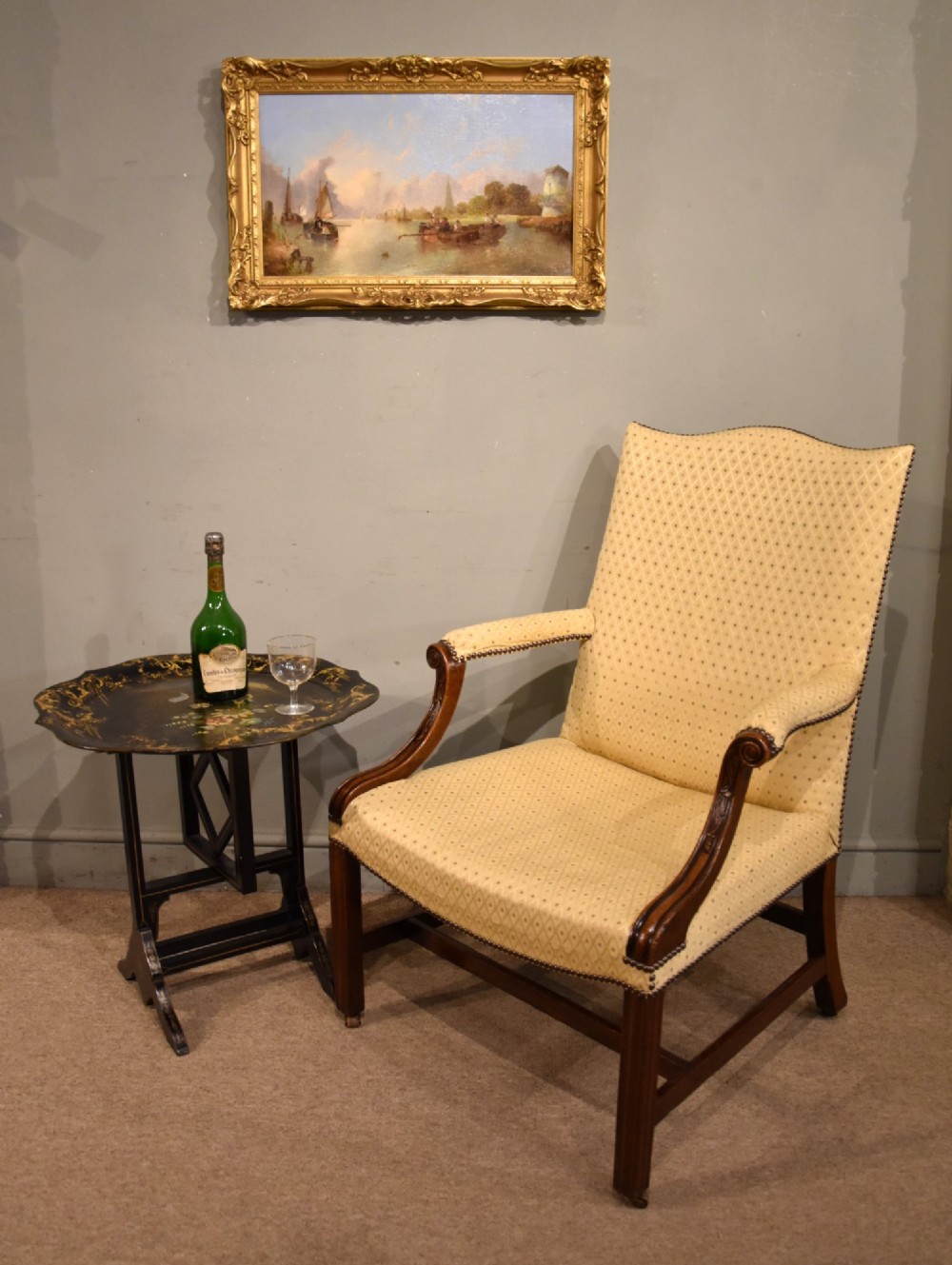 A George III mahogany Gainsborough library armchair upholstered in yellow patterned fabric with scroll arms and brass stud trim. View VII