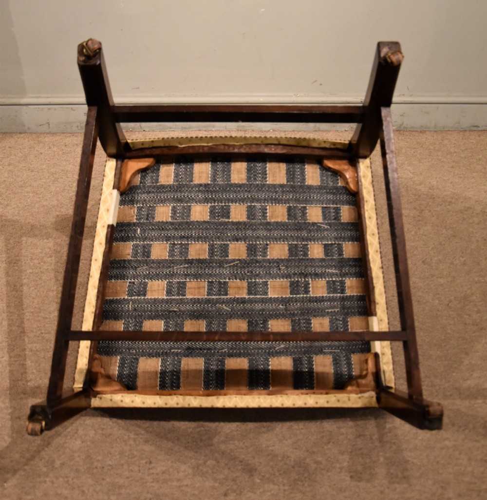A George III mahogany Gainsborough library armchair upholstered in yellow patterned fabric with scroll arms and brass stud trim. View VIII