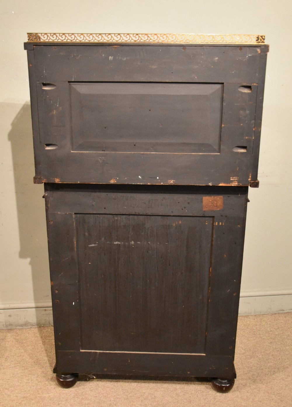 A George IV rosewood chiffonier featuring a raised mirrored back shelf with turned columns and a top brass gallery, set above a lower cupboard door with a pleated cream fabric panel. View VII