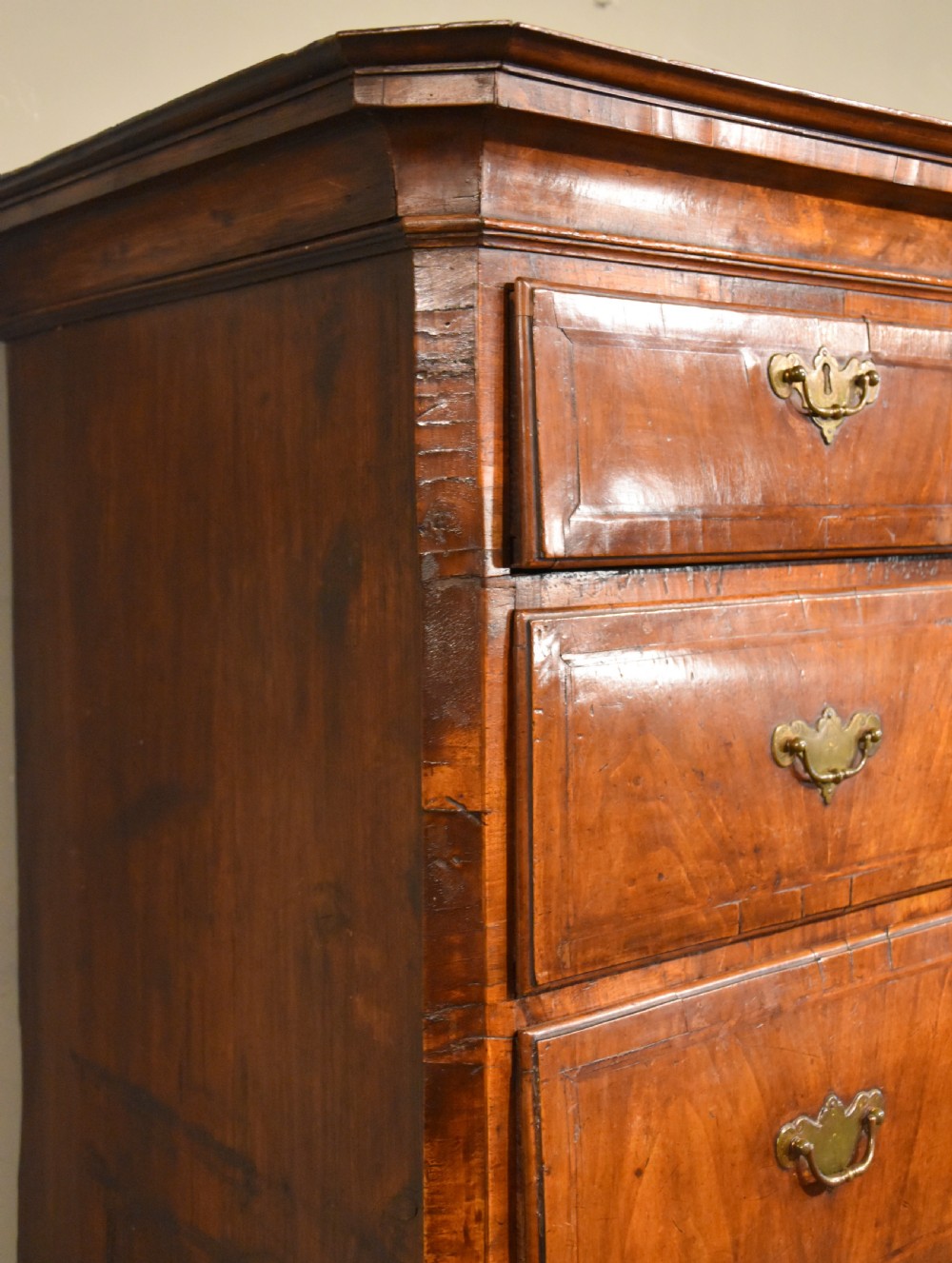 A George III walnut chest on chest featuring two short over three long drawers on the upper section and two short over two long drawers below, set on bracket feet with brass handles. View III