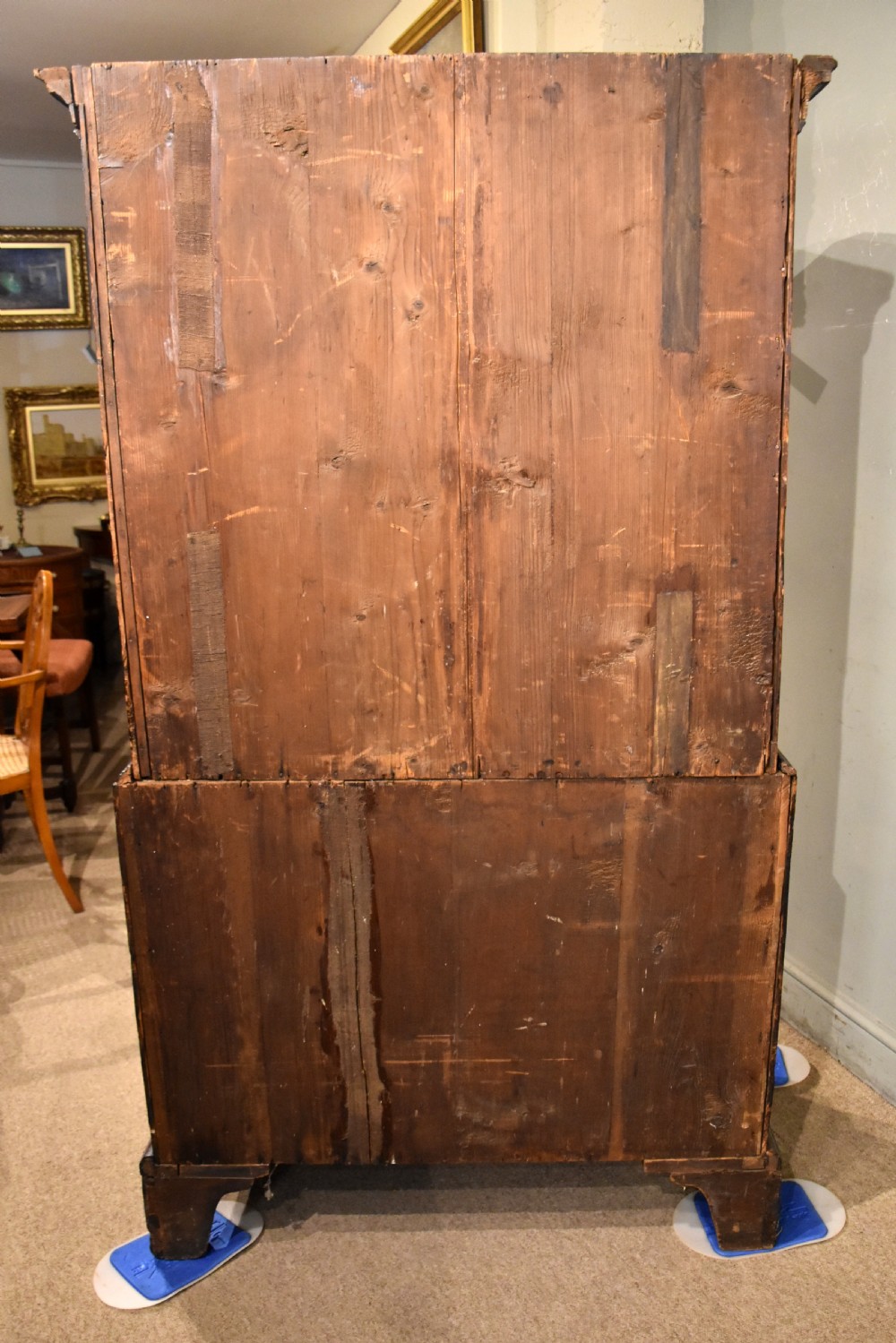 A George III walnut chest on chest featuring two short over three long drawers on the upper section and two short over two long drawers below, set on bracket feet with brass handles. View VI