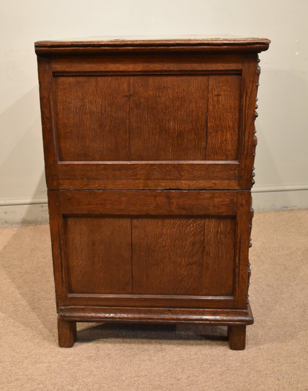 A Charles II oak chest of drawers featuring geometric panelled drawer fronts, split-baluster mouldings, brass drop handles, and escutcheons. View VI