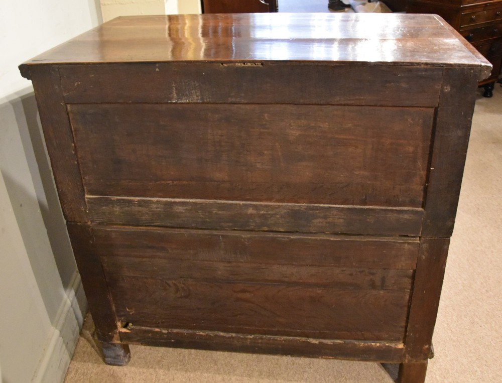 A Charles II oak chest of drawers featuring geometric panelled drawer fronts, split-baluster mouldings, brass drop handles, and escutcheons. View VII