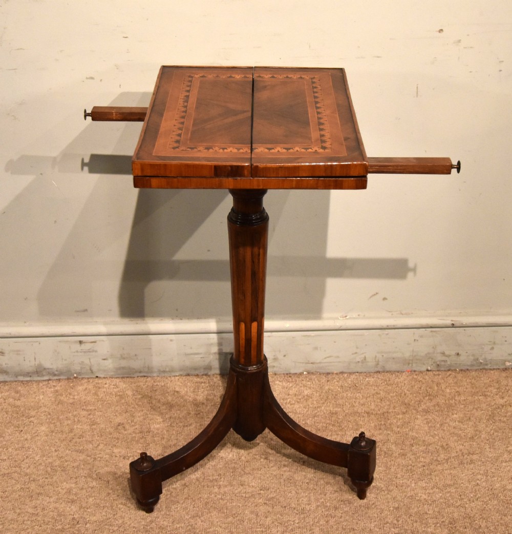 A Regency period patience table featuring an olive wood and satinwood inlaid top on a turned pedestal with three splayed legs. View II