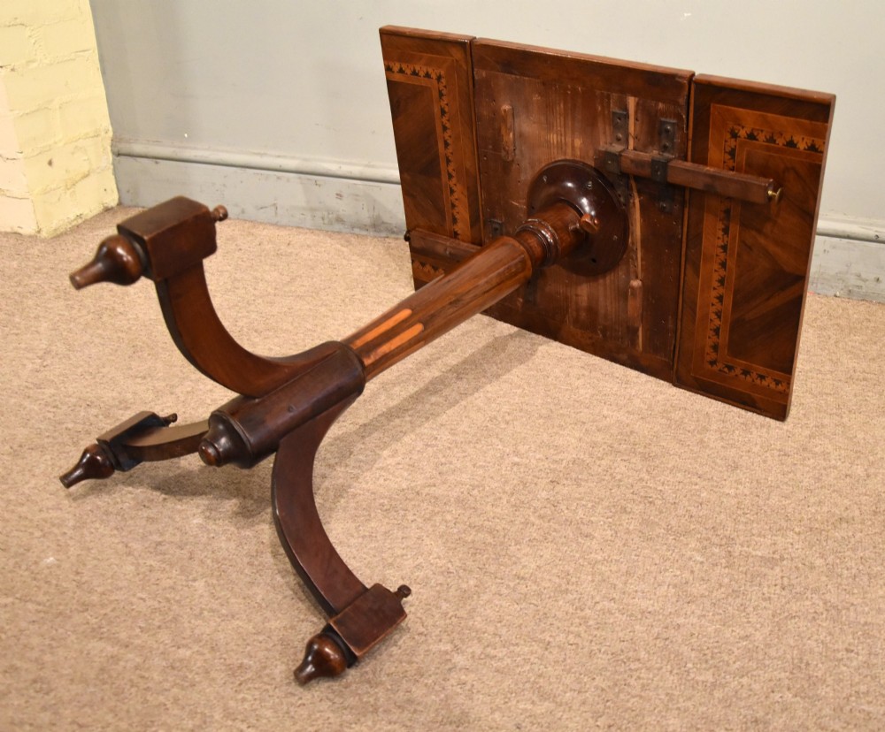 A Regency period patience table featuring an olive wood and satinwood inlaid top on a turned pedestal with three splayed legs. View VI