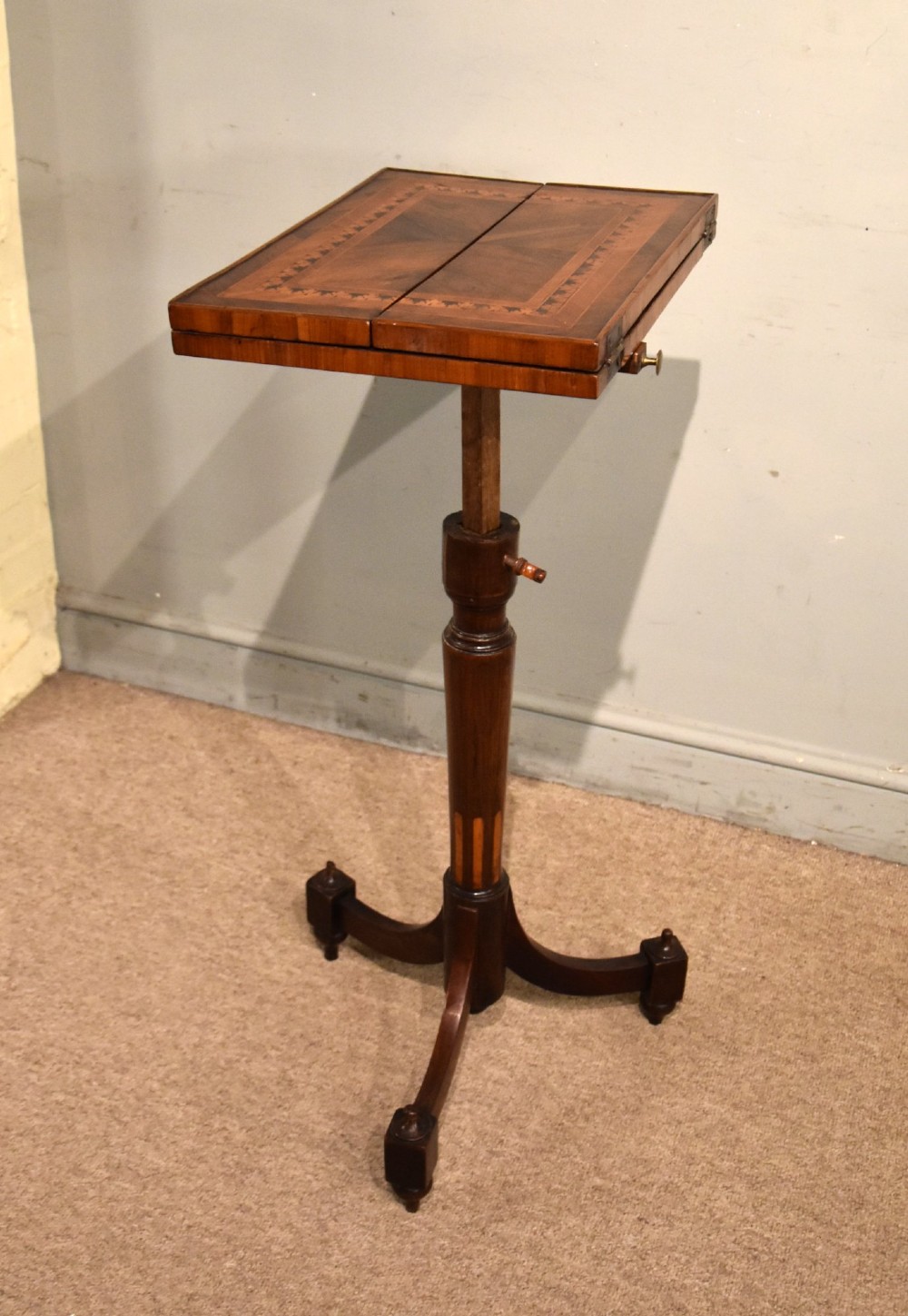 A Regency period patience table featuring an olive wood and satinwood inlaid top on a turned pedestal with three splayed legs. View VIII