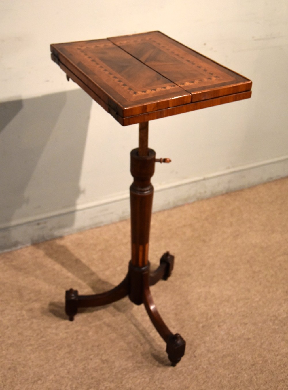 A Regency period patience table featuring an olive wood and satinwood inlaid top on a turned pedestal with three splayed legs. View IX
